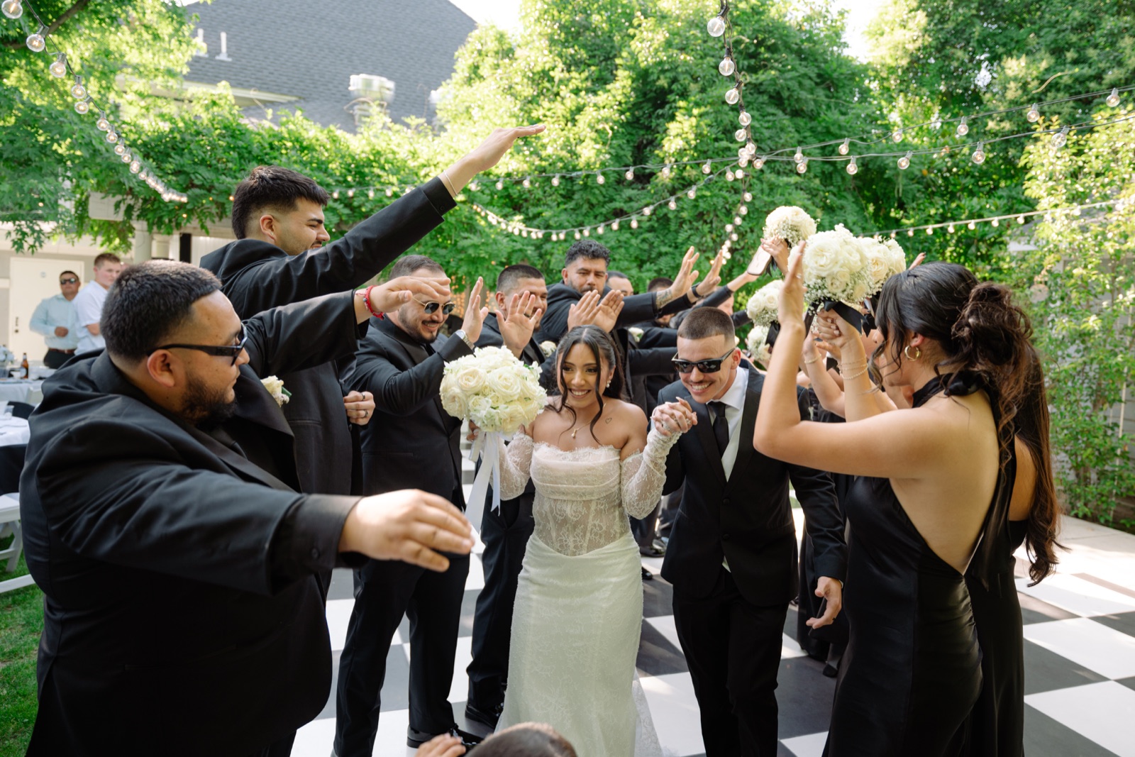 Wedding party celebrating with the bride and groom on the dance floor